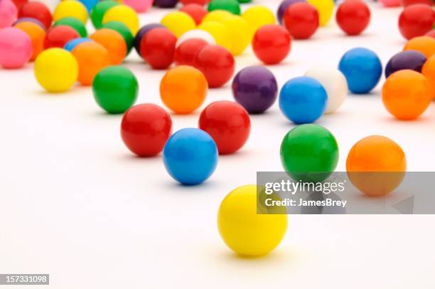 festive, colorful gum balls candy rolling, white background surface - coloured balls stockfoto's en -beelden