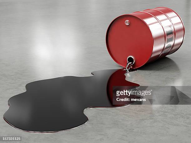 oil spilling from red barrel onto floor - oil barrel stock pictures, royalty-free photos & images