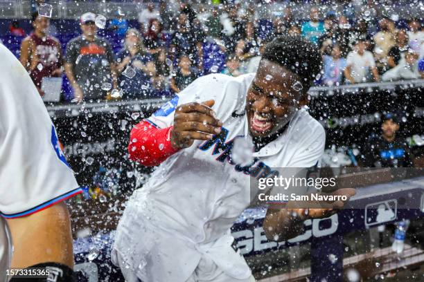 Jesus Sanchez of the Miami Marlins celebrates with teammates after hitting a walk-off single against the Philadelphia Phillies during the 12th inning...