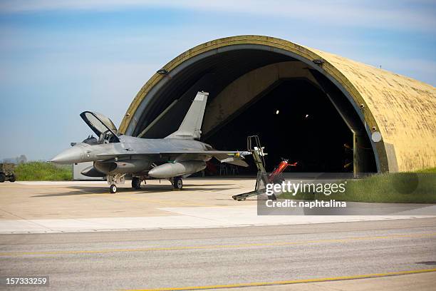f16 and hangar - airplane hangar stock pictures, royalty-free photos & images