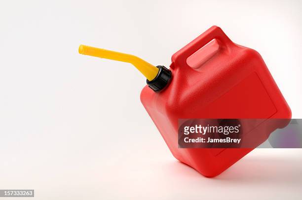 red and yellow gas can tipping with clipping path - benzinekan stockfoto's en -beelden