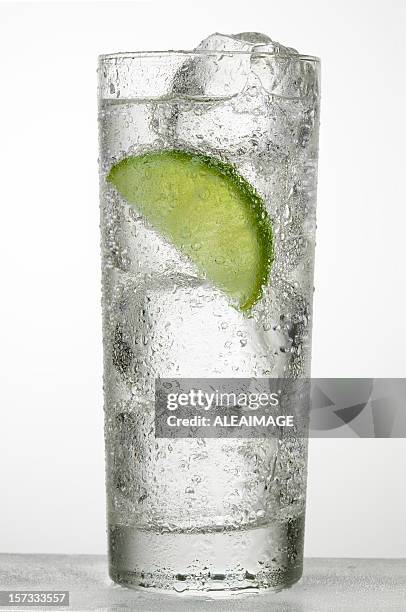 a glass of cold water with a slice of lime - soda drink stock pictures, royalty-free photos & images