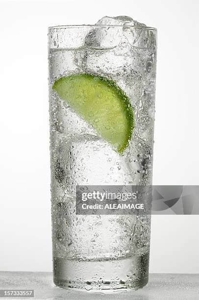 a glass of cold water with a slice of lime - condensation on drinking glass stock pictures, royalty-free photos & images