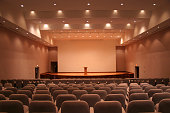 Empty auditorium with grey seats and downlights