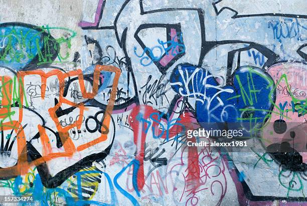 colorful graffiti on a cement wall - vandalism 個照片及圖片檔