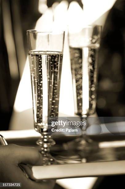 two champagne glasses on tray - galadinner stock pictures, royalty-free photos & images