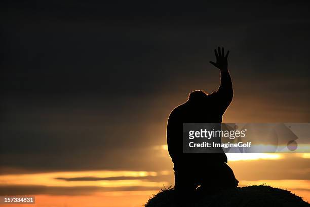 silhouette of a man seeking god - arms raised sunrise stock pictures, royalty-free photos & images