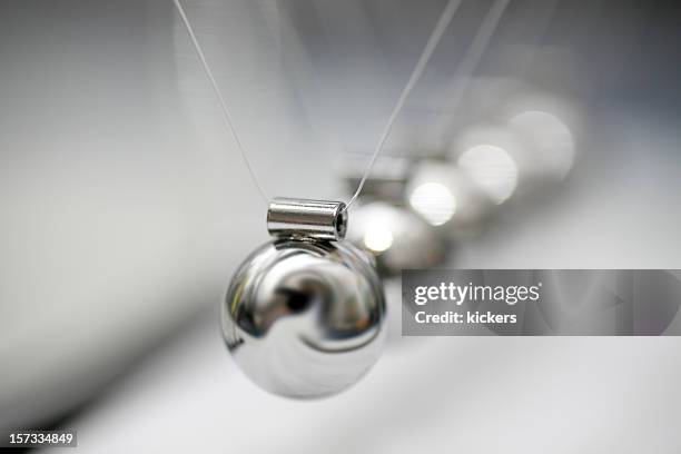 shinny and metal newton's cradle - newtons cradle stock pictures, royalty-free photos & images