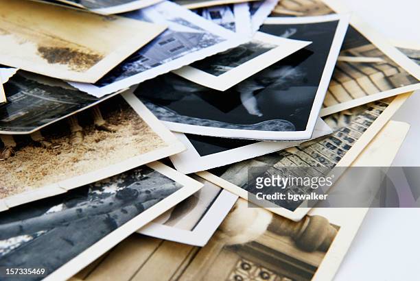old vintage retro candid photographs in a pile - memories stock pictures, royalty-free photos & images