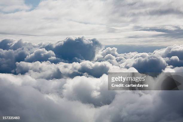 fluffy white clouds from above - wolkenlandschap stockfoto's en -beelden