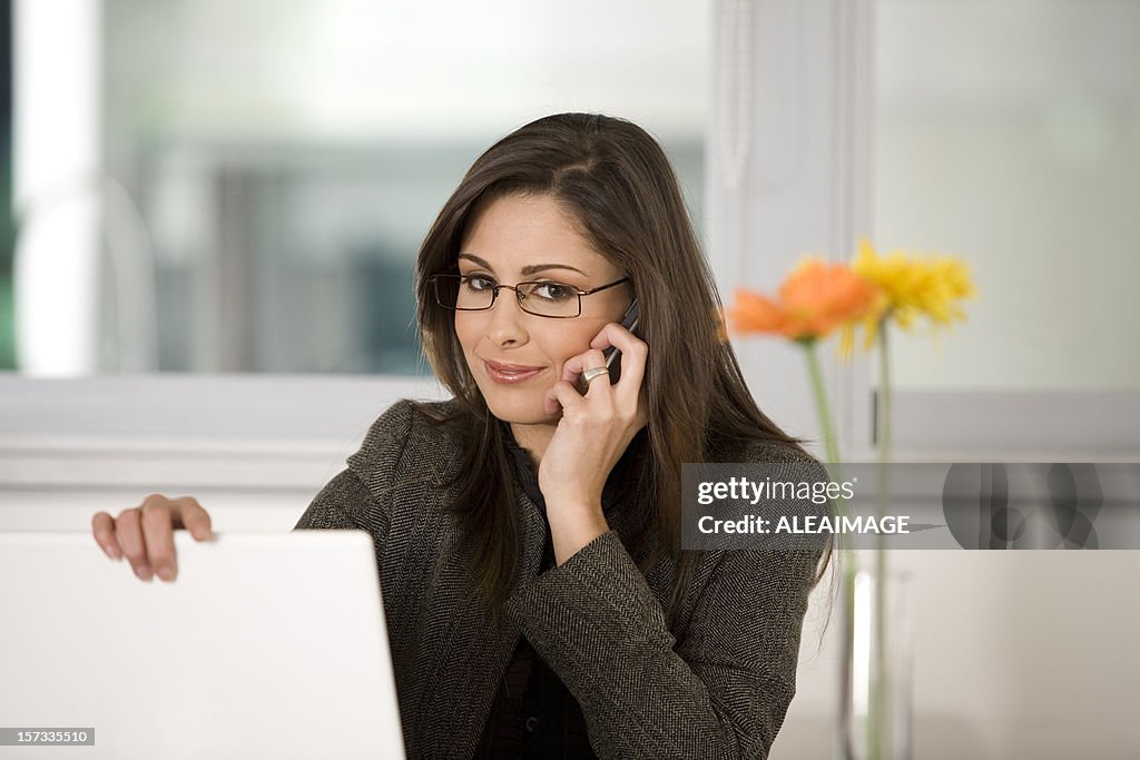 Bussines woman on the phone with laptop