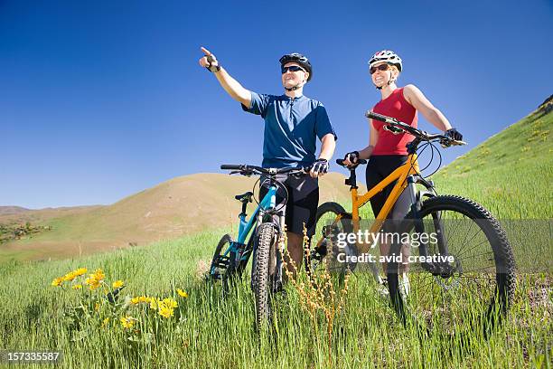 happy mountain biking couple - bike flowers stock pictures, royalty-free photos & images