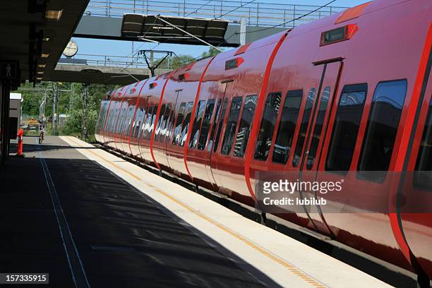 red local train on taastrup station in denmark - danish culture stock pictures, royalty-free photos & images