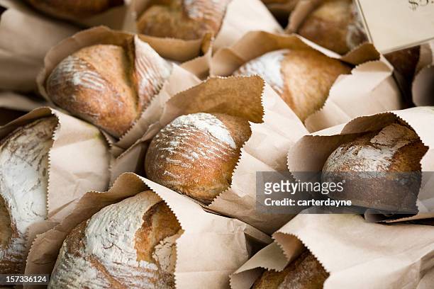 freshly baked bread in bags at a farmers market - loaf of bread bildbanksfoton och bilder