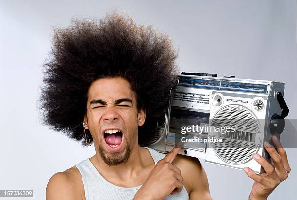 funky man singing to music on portable radio - portable radio stock pictures, royalty-free photos & images