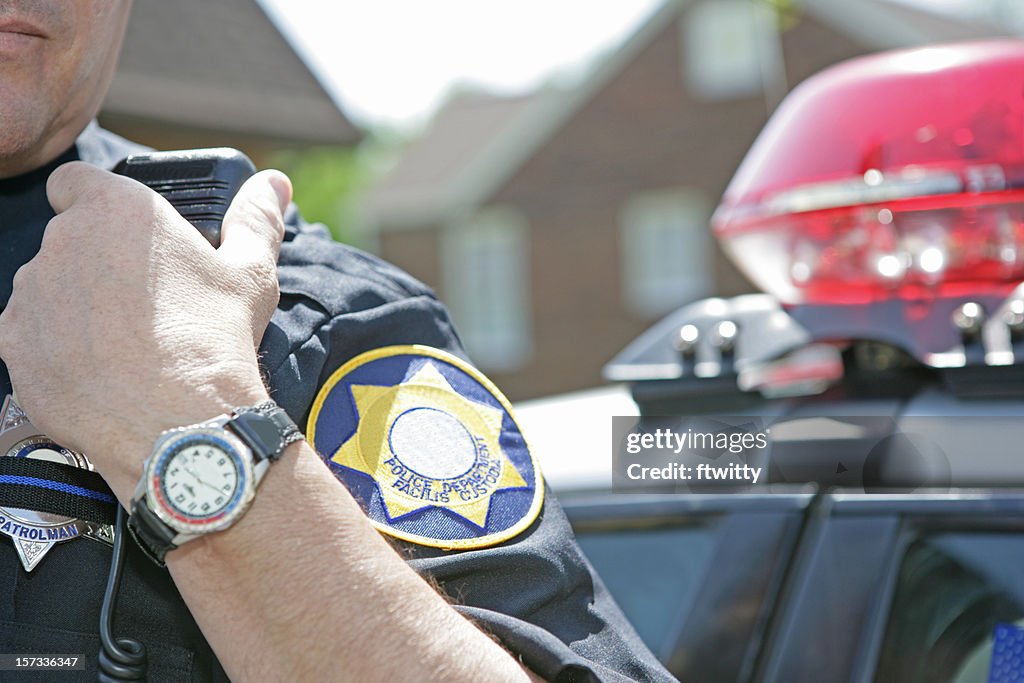 Police officer using radio to call for backup