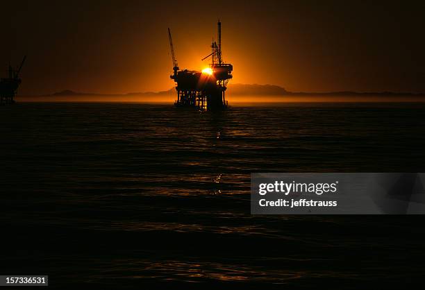 oil-well at sunset - oliewerker stockfoto's en -beelden