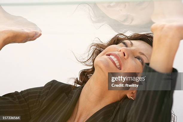 woman in a glass box trying to get out by punching the roof  - glass ceiling stock pictures, royalty-free photos & images