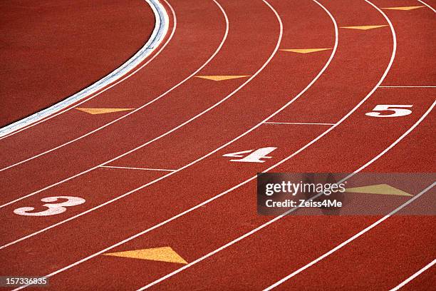 curving lanes of track - university athletics stock pictures, royalty-free photos & images