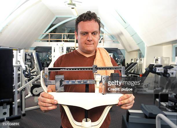 man looking at the scale numbers - pound unit of mass stock pictures, royalty-free photos & images
