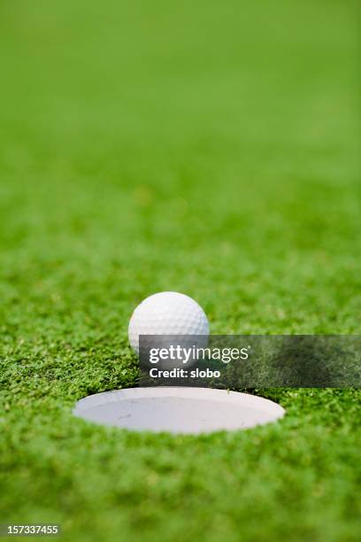hole in one - golf ball stock pictures, royalty-free photos & images