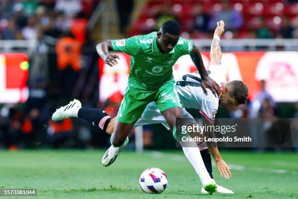 Luiz Henrique Andre of Betis competes for the ball with Alejandro Dario Gomez of Sevilla during the preseason friendly match between Sevilla and...