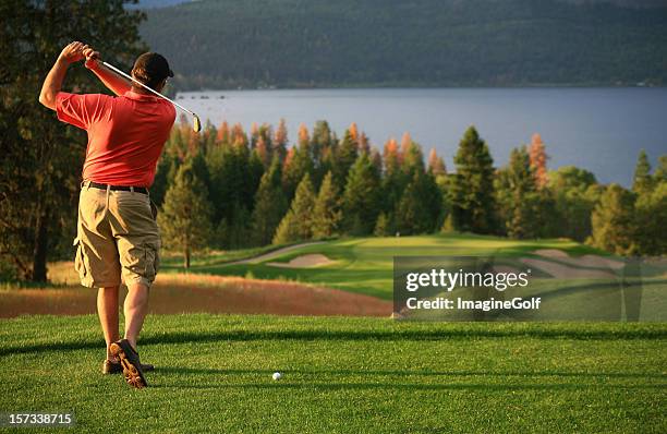 male caucasian golfer on the tee - golf swing from behind stock pictures, royalty-free photos & images