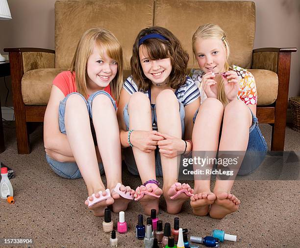 girls doing their nails - beautiful barefoot girls stockfoto's en -beelden