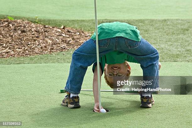 boy playing golf - mini golf stock pictures, royalty-free photos & images