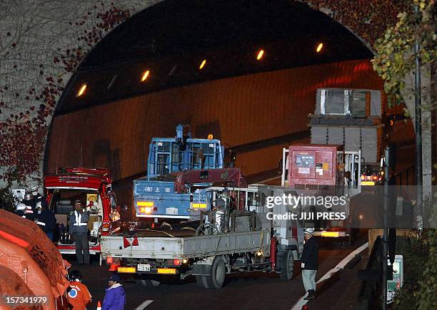 Operation vehicles continue with the rescue as they enter the Sasago tunnel along the Chuo highway near the city of Otsuki in Yamanashi prefecture,...