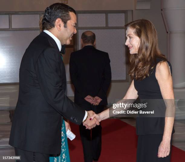 Prince Moulay Rachid of Morocco greets Isabelle Huppert before the Gala Dinner at the Tribute to Hindi Cinema ceremony at the 12th Marrakech...