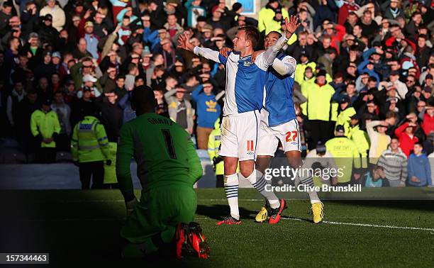 Jordan Rhodes of Blackburn Rovers celebrates after scoring the first goal with team mate Adam Henley as Burnley goal keeper Lee Grant looks on during...