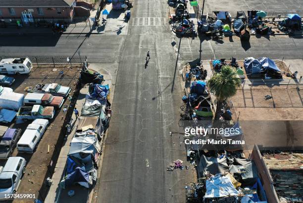 In an aerial view, people walk through a section of the 'The Zone', Phoenix's largest homeless encampment, amid the city's worst heat wave on record...