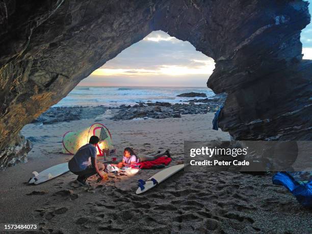 young couple wild camping on beach - newquay stock pictures, royalty-free photos & images