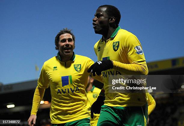 Sebastien Bassong of Norwich City celebrates scoring the opening goal with team mate Grant Holt during the Barclays Premier League match between...