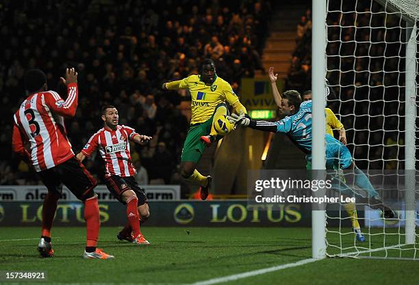 Sebastien Bassong of Norwich City scores the opening goal past Simon Mignolet of Sunderland during the Barclays Premier League match between Norwich...