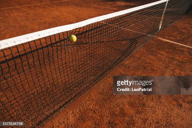 tennis ball hits in the net - tennis ball stock pictures, royalty-free photos & images