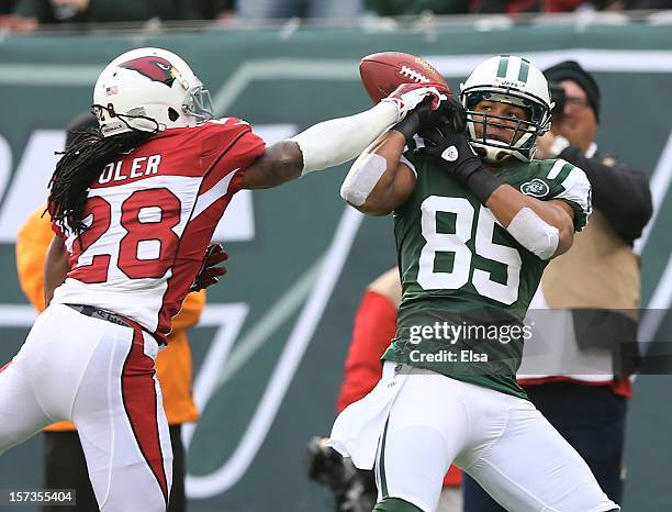 Greg Toler of the Arizona Cardinals knocks the ball from Chaz Schilens of the New York Jets on December 2, 2012 at MetLife Stadium in East...
