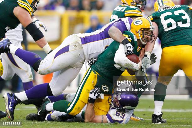 Aaron Rodgers of the Green Bay Packers gets sacked by Jared Allen of the Minnesota Vikings during the game at Lambeau Field on December 2, 2012 in...