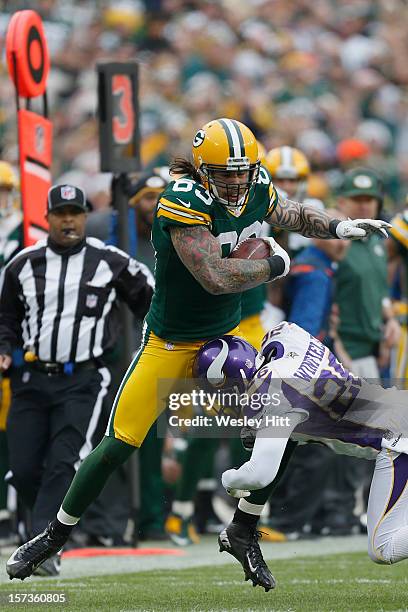 Tom Crabtree of the Green Bay Packers is tackled by Antoine Winfield of the Minnesota Vikings at Lambeau Field on December 2, 2012 in Green Bay,...