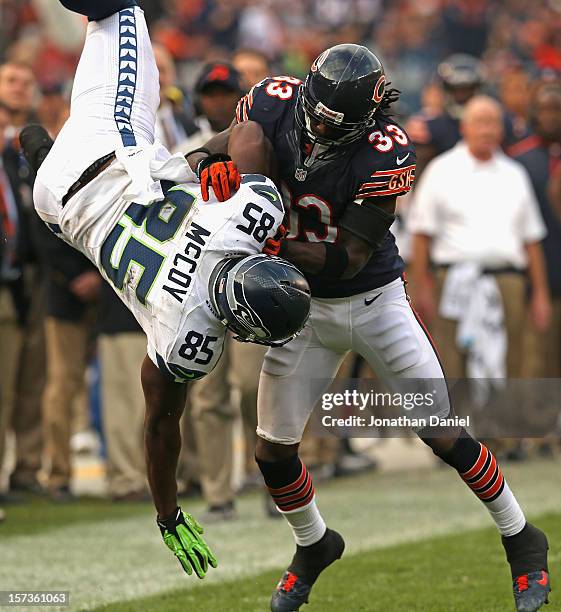 Charles Tillman of the Chicago Bears upends Anthony McCoy of the Seattle Seahawks at Soldier Field on December 2, 2012 in Chicago, Illinois. The...