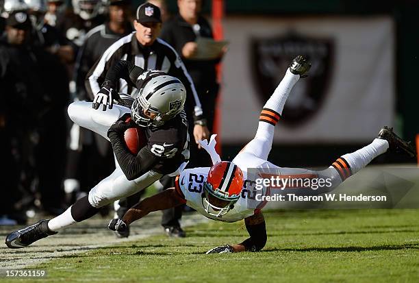 Juron Criner of the Oakand Raiders after an eight yard reception is tackled out of bounds by Joe Haden of the Cleveland Browns during the first...