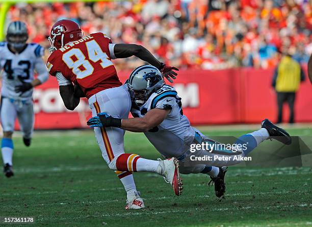 Linebacker Jason Phillips of the Carolina Panthers tackles wide receiver Jamar Newsome of the Kansas City Chiefs during the first half on December 2,...