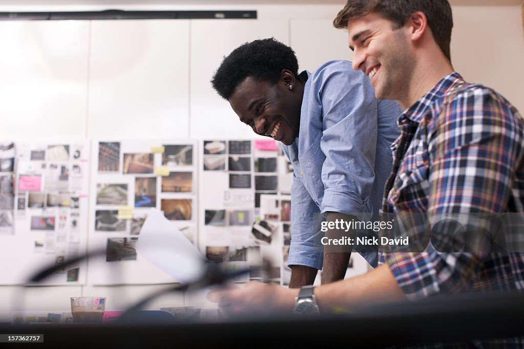 Two male business colleagues working together in an office environment