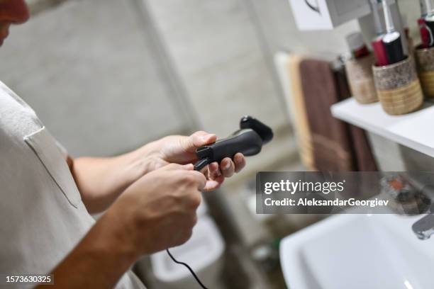 modern male preparing trimmer for beard shaving - razor stock pictures, royalty-free photos & images