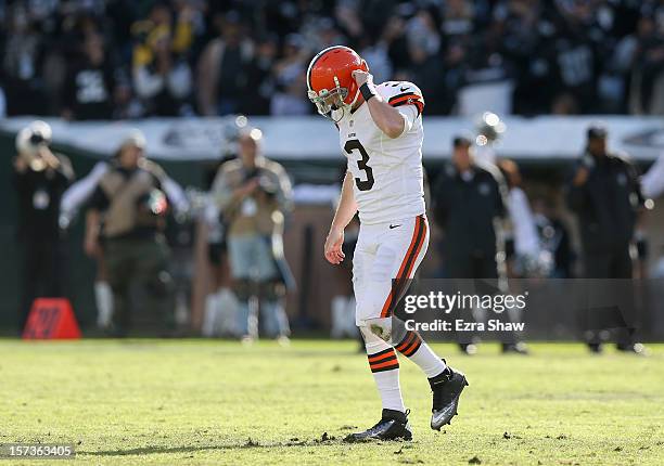 Brandon Weeden of the Cleveland Browns walks off the field after throwing an interception against the Oakland Raiders at O.co Coliseum on December 2,...