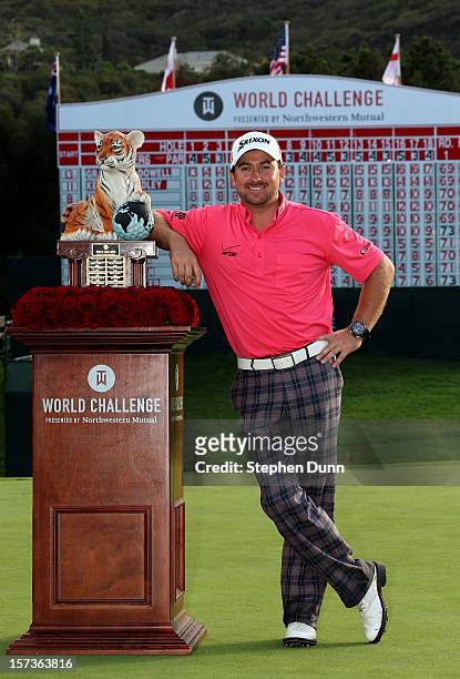 Graeme McDowell of Northern Ireland poses with the trophy after his three stroke victory in the final round of the Tiger Woods World Challenge...