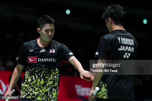 Takuro Hoki and Yugo Kobayashi of Japan react in the Men's Doubles Second Round match against Ren Xiangyu and Tan Qiang of China on day three of the...