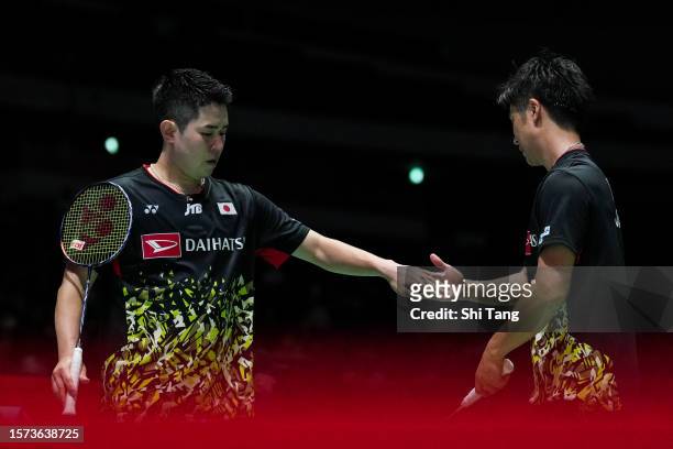 Takuro Hoki and Yugo Kobayashi of Japan react in the Men's Doubles Second Round match against Ren Xiangyu and Tan Qiang of China on day three of the...