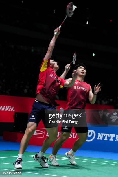 Ren Xiangyu and Tan Qiang of China compete in the Men's Doubles Second Round match against Takuro Hoki and Yugo Kobayashi of Japan on day three of...